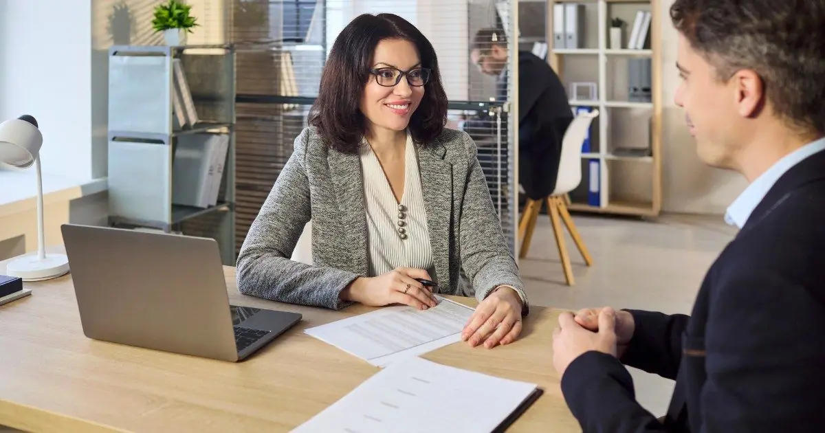 An MRE team member reviewing documents with a client