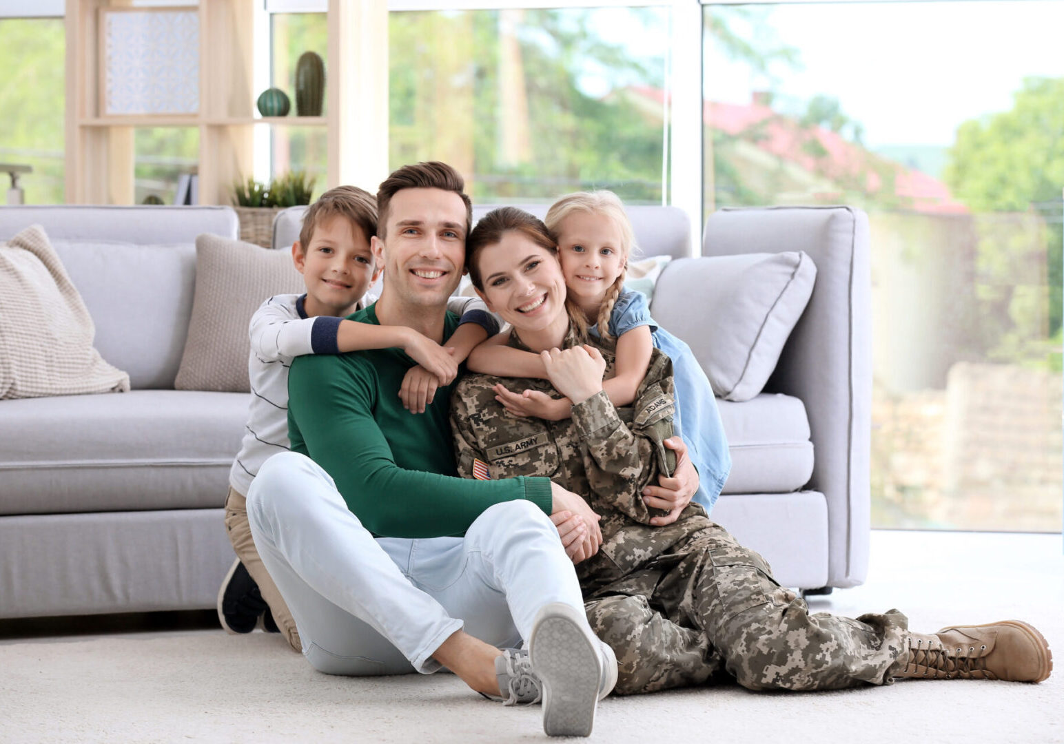 Woman in military uniform with her family at home